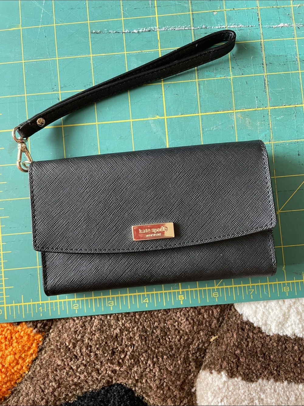 Kate Spade black saffiano wristlet clutch with gold plaque